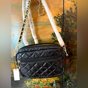 Thomas & Lee quilted black cross body bag with black and gold braided chain .